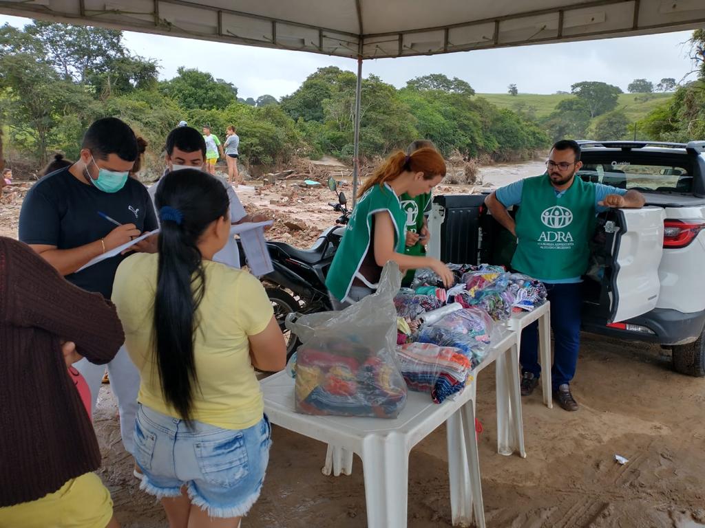 Voluntários e funcionários de ADRA entregando kits de higiene